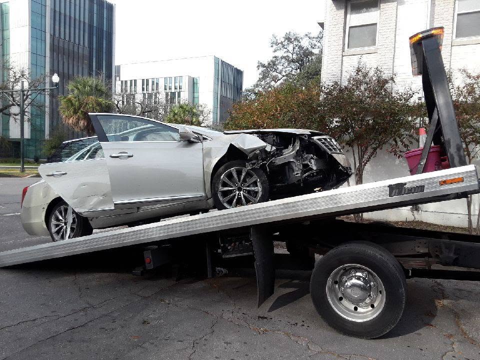 Baby Kaityln flatbed truck with crashed car on the bed in New Orleans