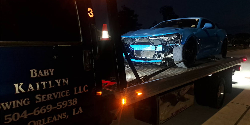 Baby Kaitlyn Towing Flatbed Truck with wrecked Camero on the bed